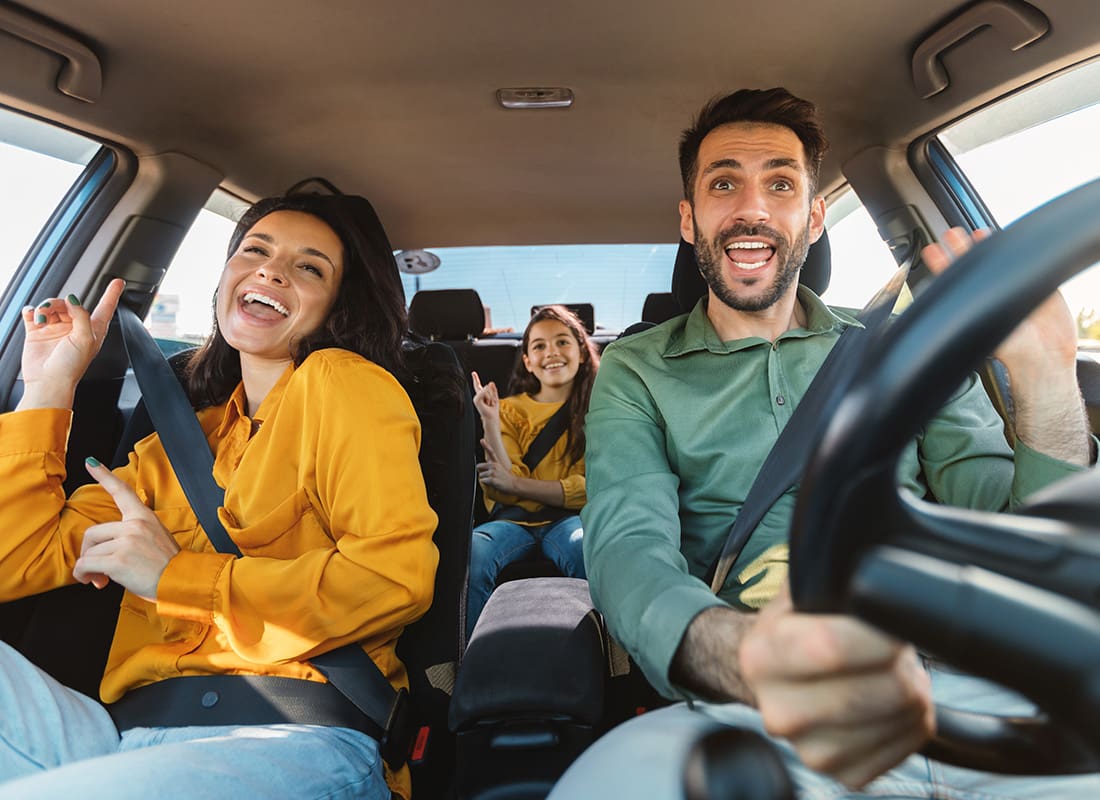 Insurance Solutions - Portrait of a Cheerful Family Having Fun Singing While Taking a Road Trip in a Car